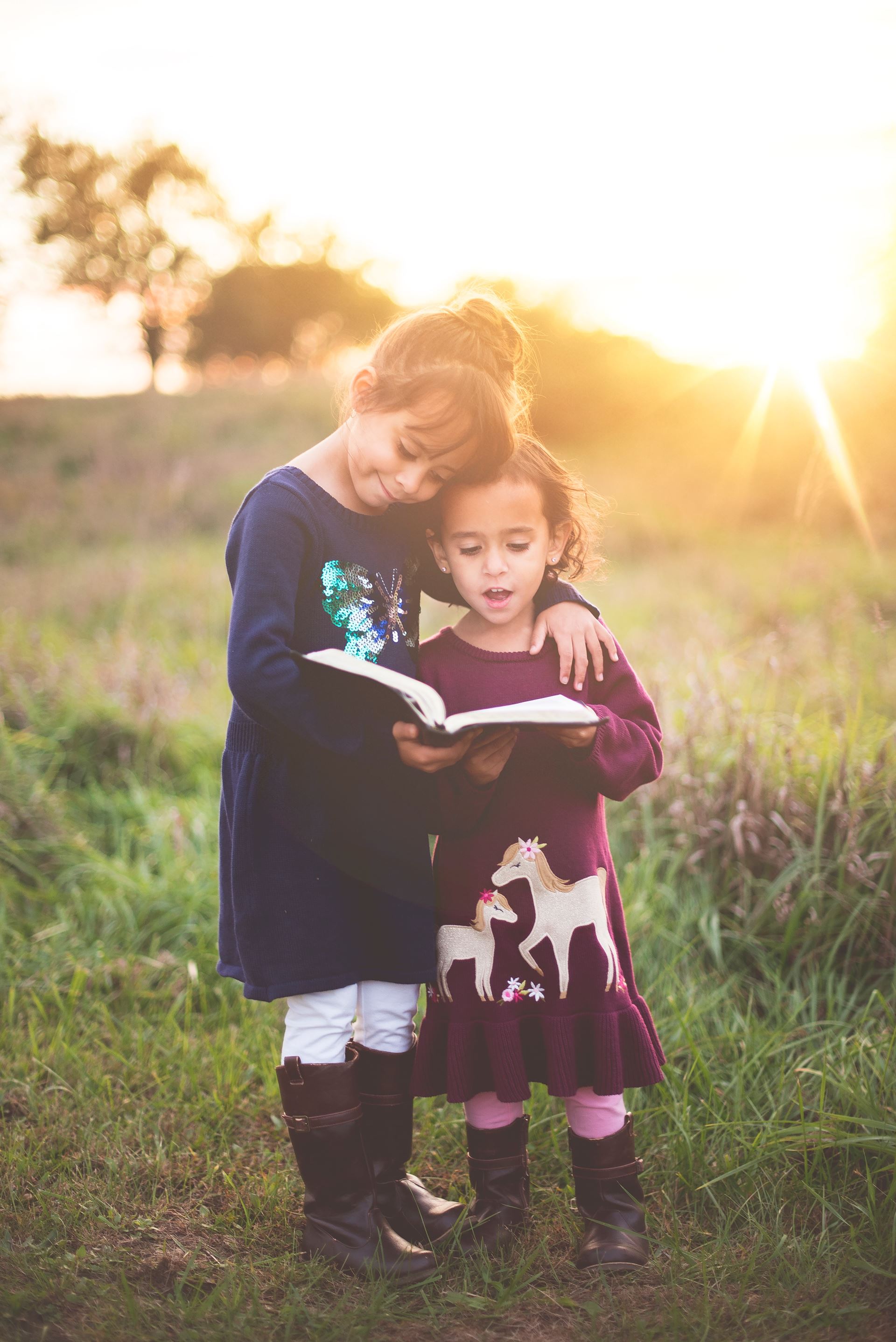 a little girl standing in a field